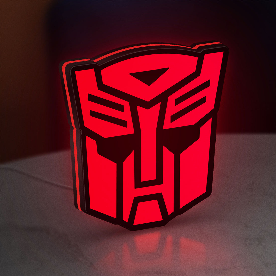 Autobot LED lightbox hanging on a wall with red glow