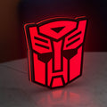 Autobot LED lightbox standing on a desk from an angled side view with red glow