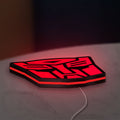 Autobot LED lightbox lying flat on a desk with red glow