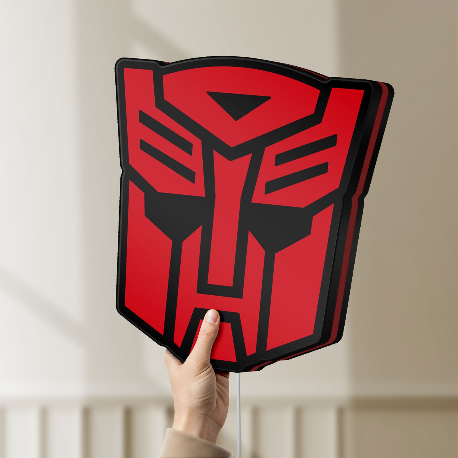 Unlit Autobot LED lightbox held by hand to show size and details
