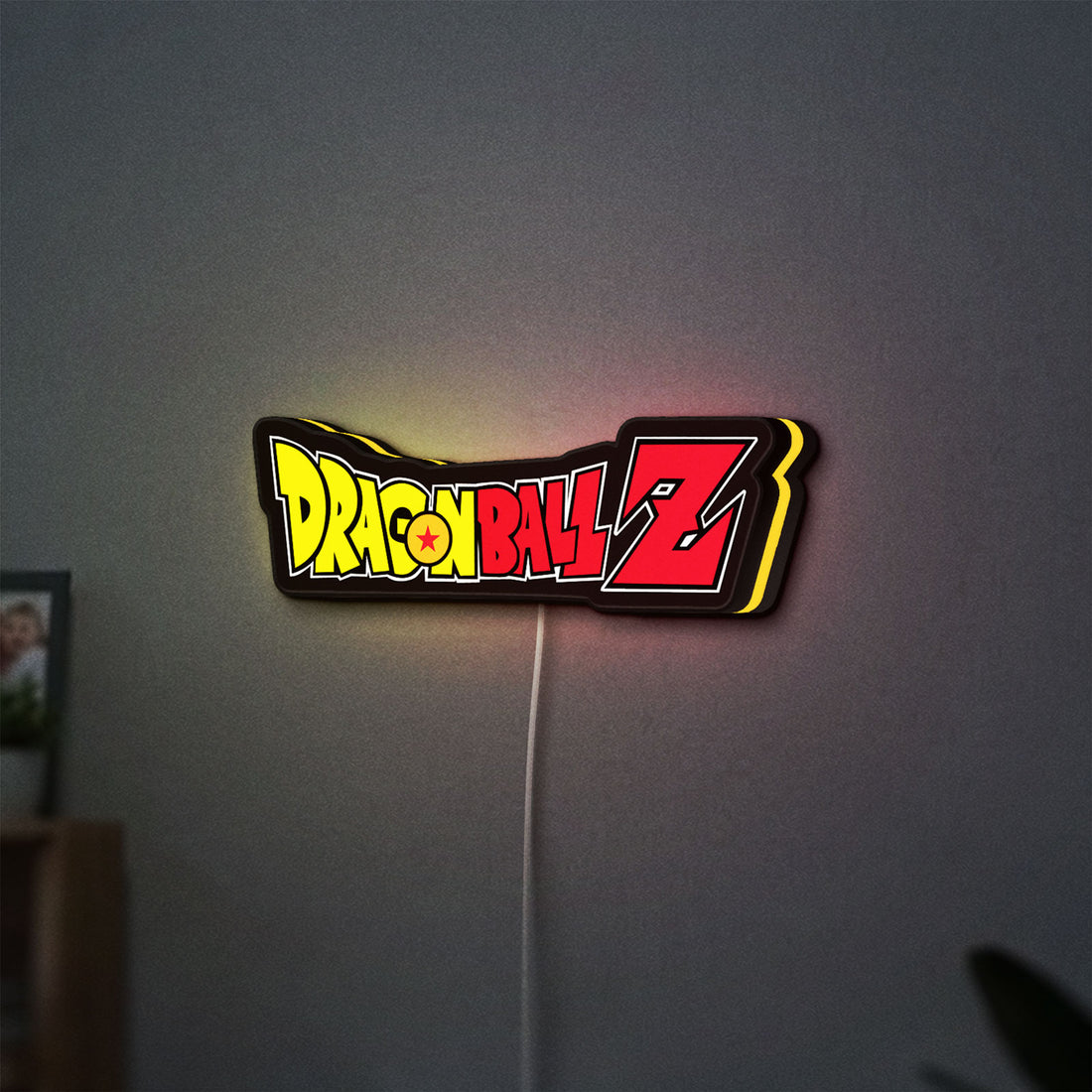 Dragon Ball Z LED lightbox hanging on a wall with yellow glow
