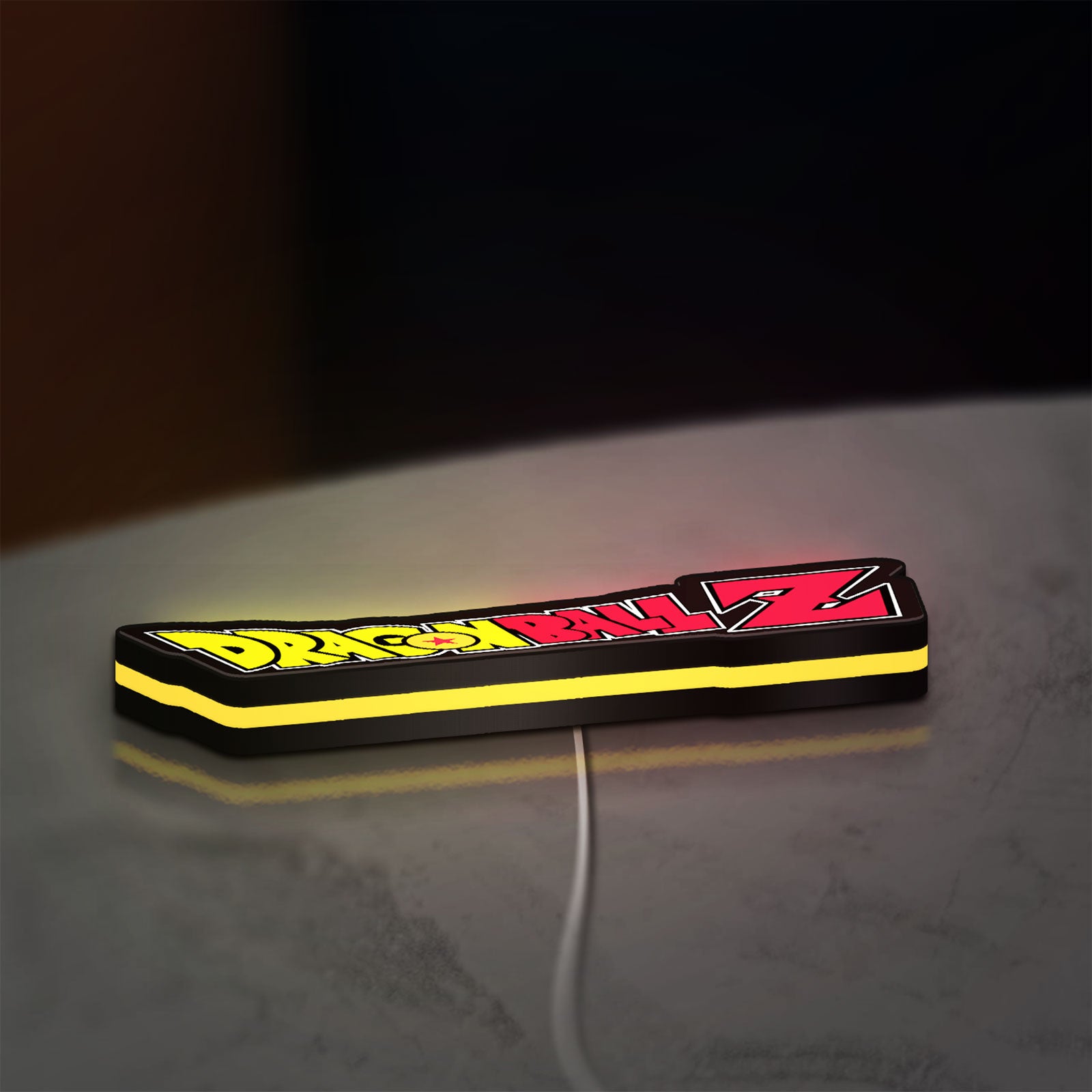 Dragon Ball Z LED lightbox lying flat on a desk with yellow glow