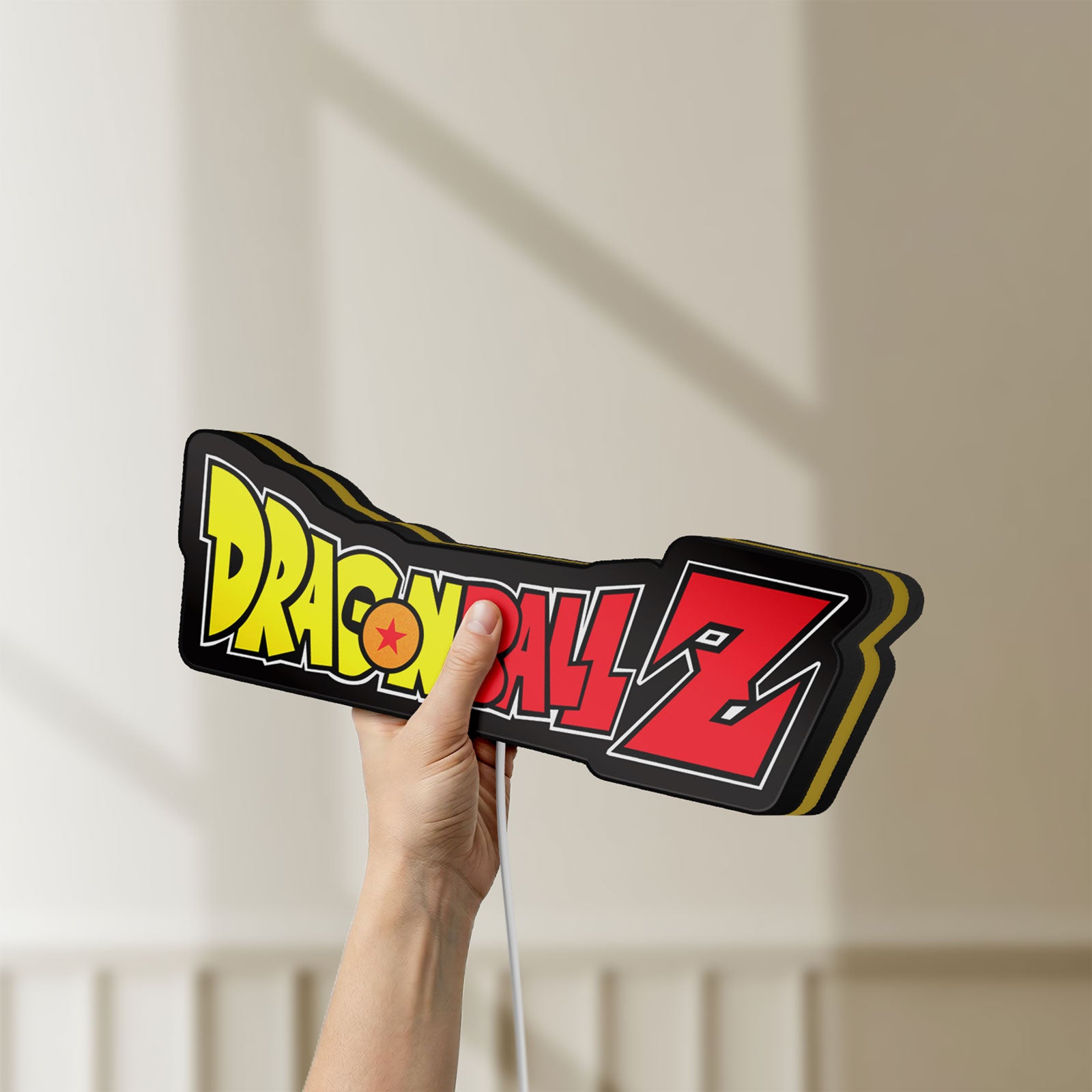 Unlit Dragon Ball Z LED lightbox held by hand to show size and details