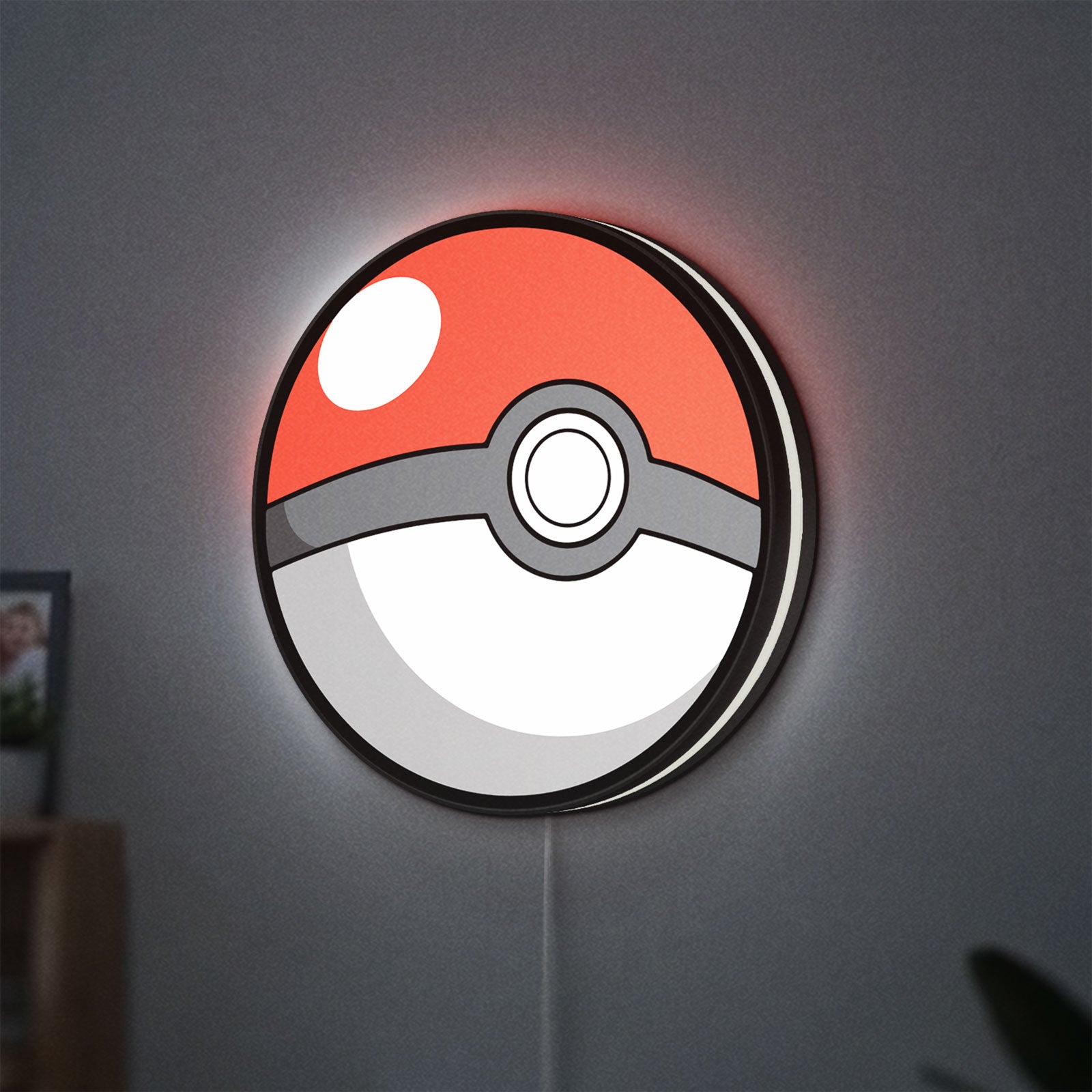 Pokeball LED lightbox hanging on a wall with white glow