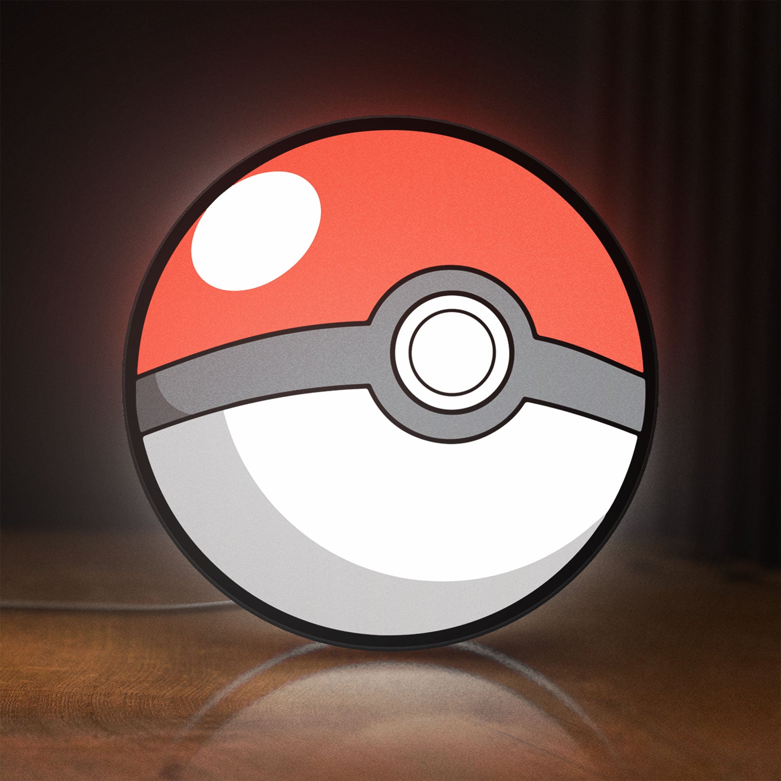 Front view of Pokeball LED lightbox sign glowing on a wooden desk
