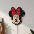 Unlit Minnie Mouse Head LED lightbox mounted on a wall in daylight