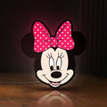 Front view of Minnie Mouse Head LED lightbox sign glowing on a wooden desk