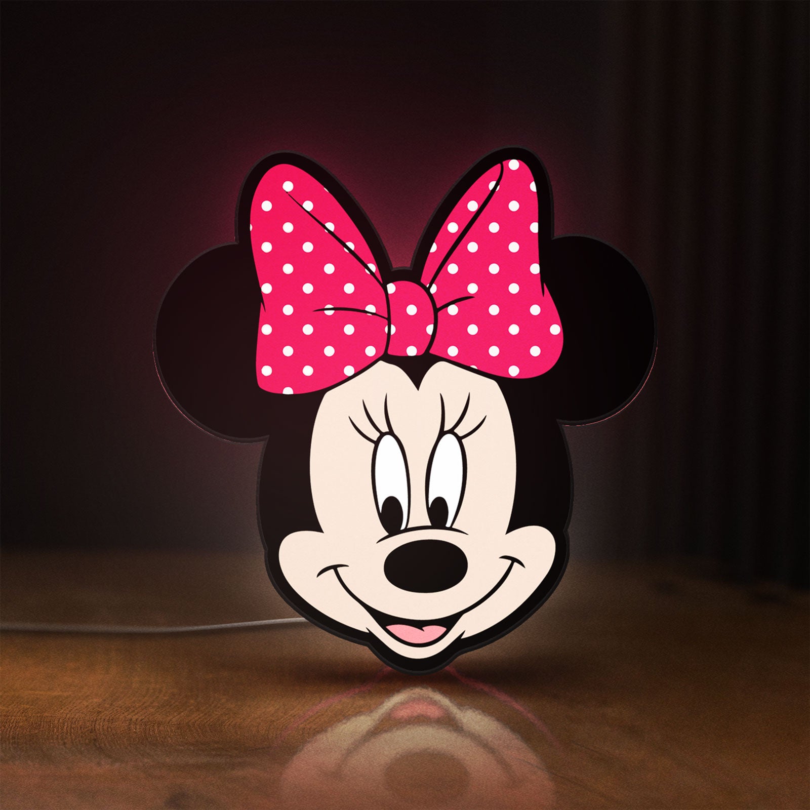 Front view of Minnie Mouse Head LED lightbox sign glowing on a wooden desk