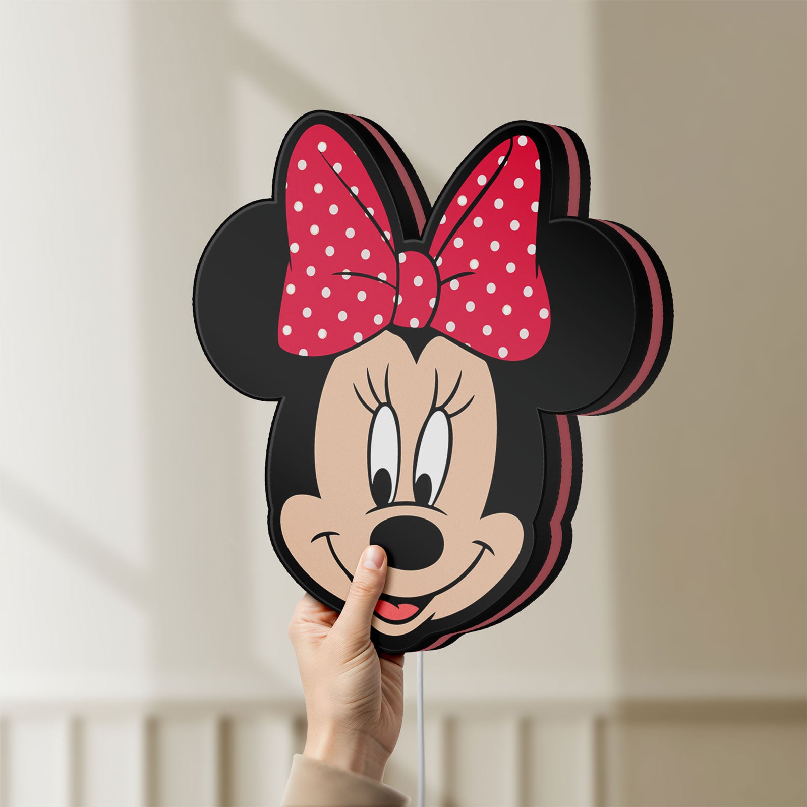 Unlit Minnie Mouse Head LED lightbox held by hand to show size and details