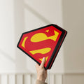 Unlit Superman S LED lightbox held by hand to show size and details