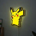 Pikachu LED lightbox hanging on a wall with yellow glow