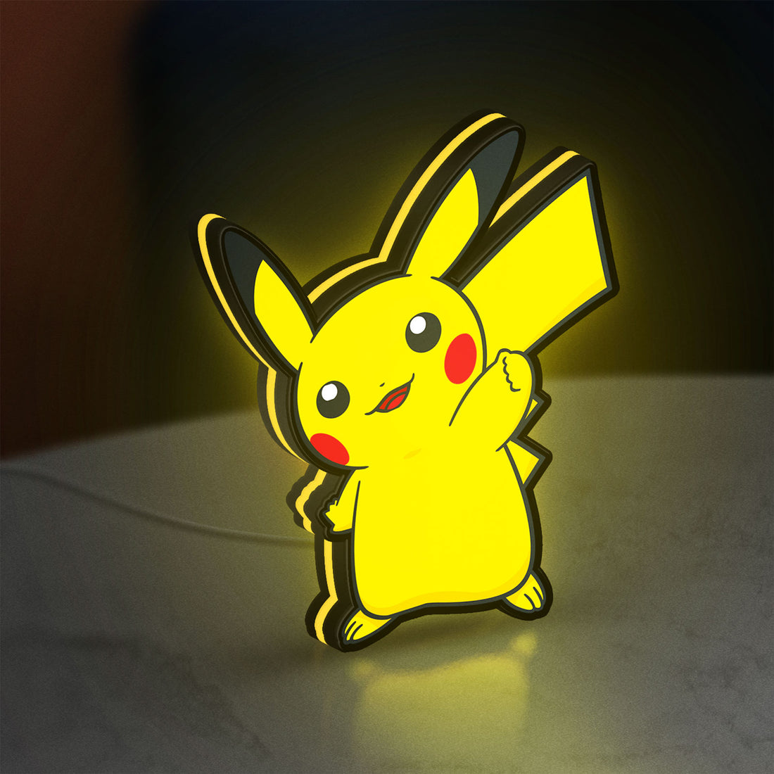 Pikachu LED lightbox hanging on a wall with yellow glow