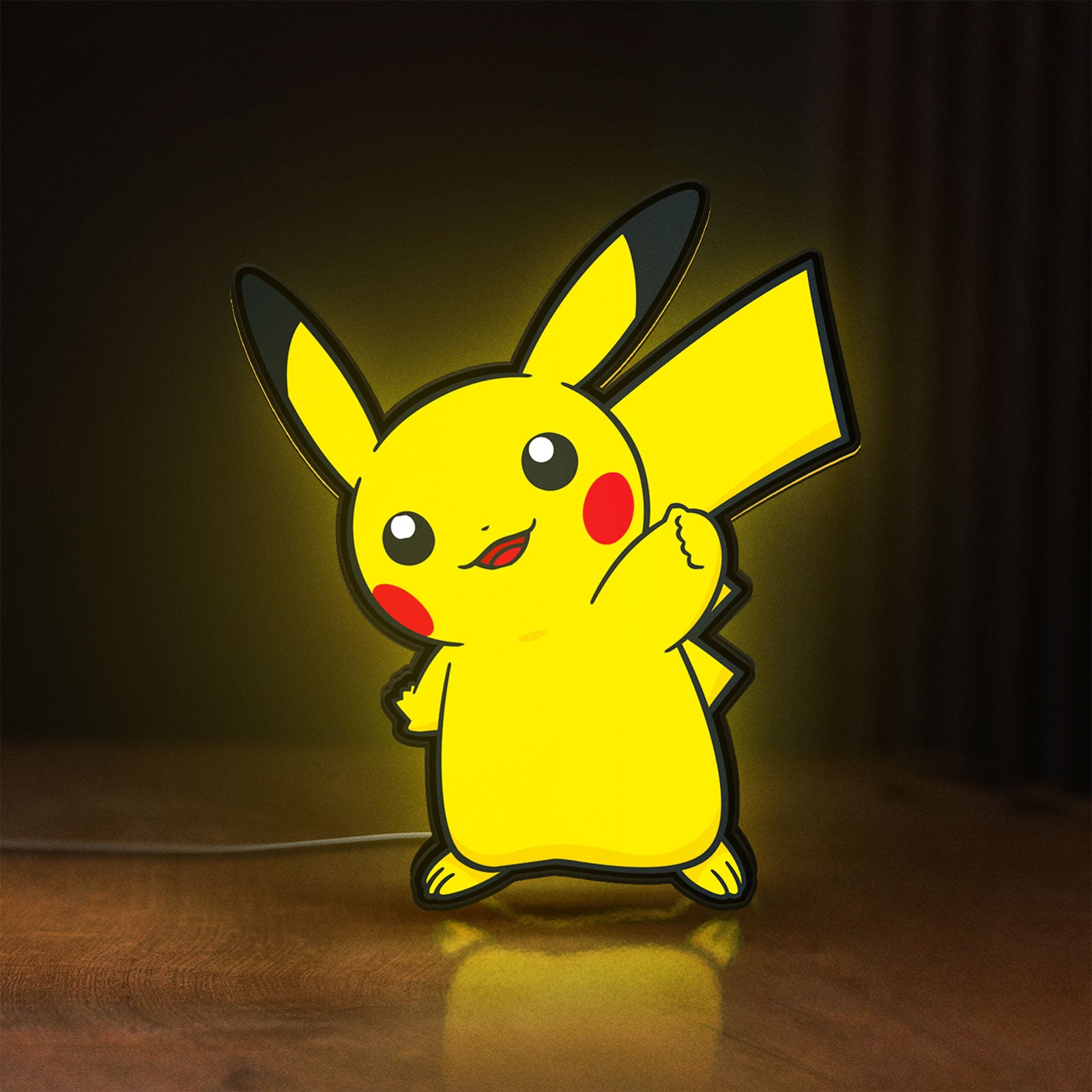Front view of Pikachu LED lightbox sign glowing on a wooden desk