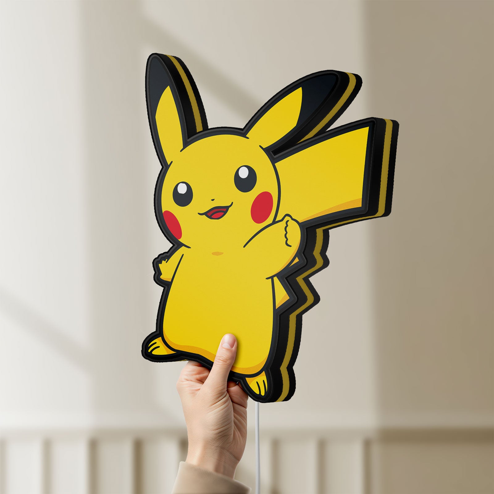 Unlit Pikachu LED lightbox held by hand to show size and details