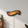 Unlit Hot Wheels Sign LED lightbox mounted on a wall in daylight