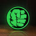 Front view of Hulk Fist LED lightbox sign glowing on a wooden desk