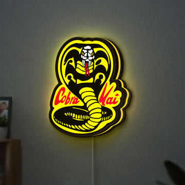Cobra Kai LED lightbox hanging on a wall with yellow glow