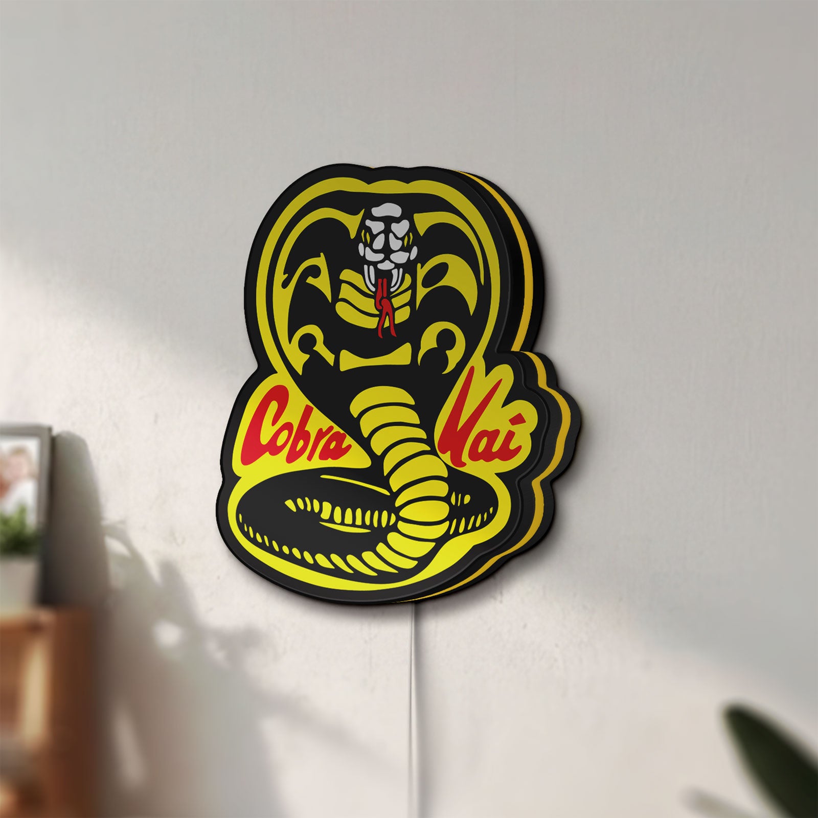 Unlit Cobra Kai LED lightbox mounted on a wall in daylight