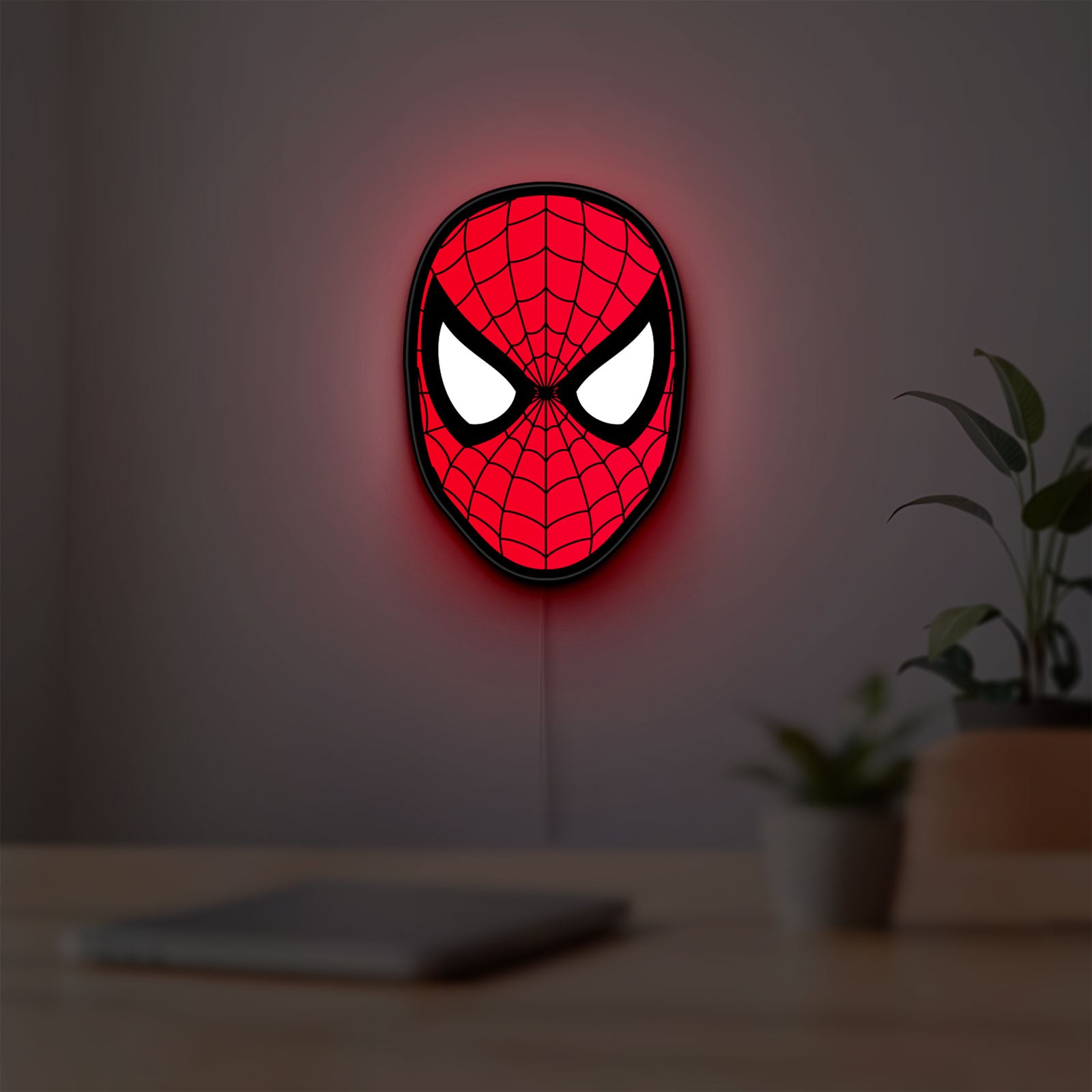 Spider-Man LED lightbox hanging on a room wall with soft red light