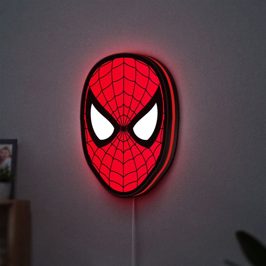 Spider-Man LED lightbox hanging on a wall with red glow