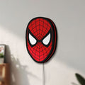 Unlit Spider-Man LED lightbox mounted on a wall in daylight