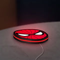 Spider-Man LED lightbox lying flat on a desk with red glow