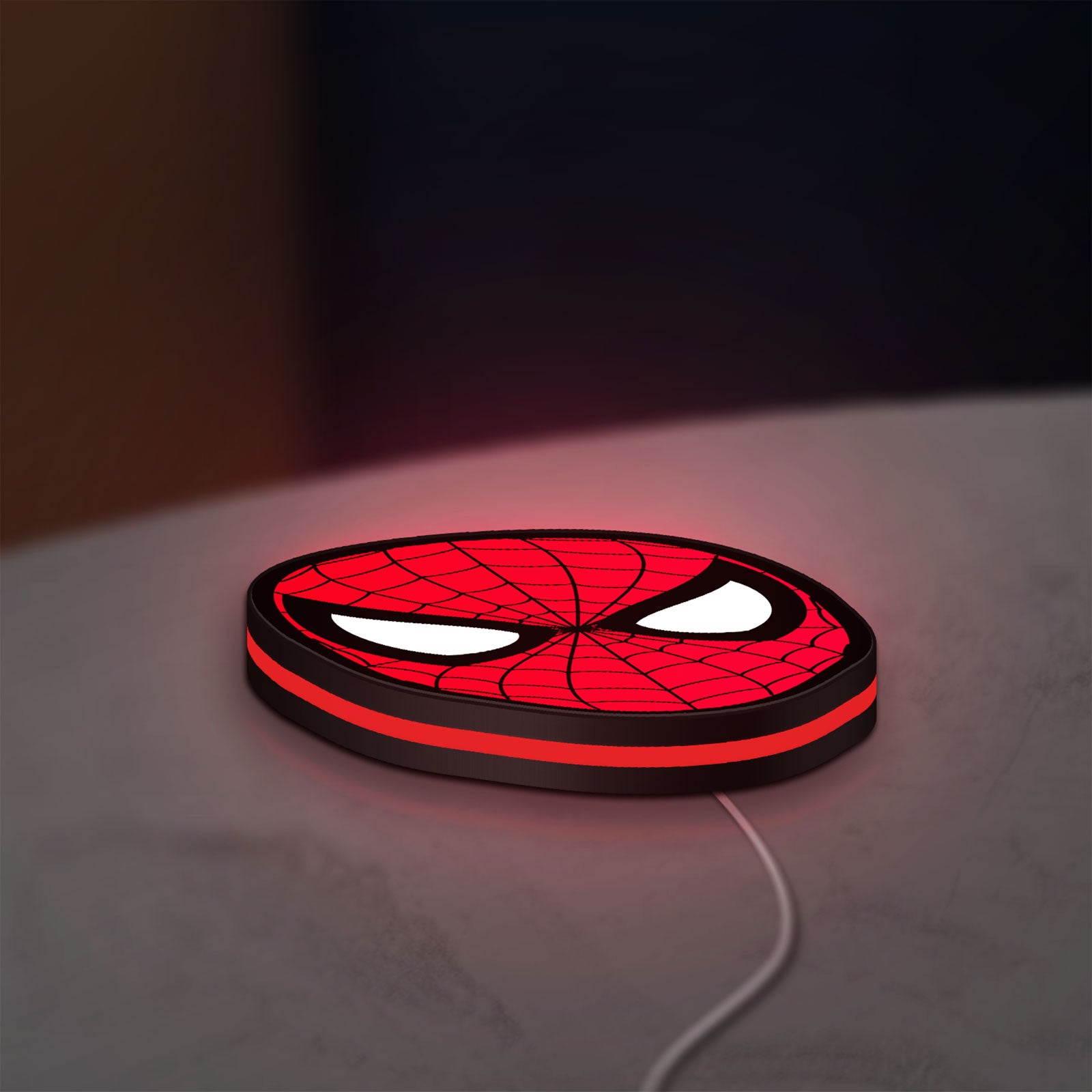 Spider-Man LED lightbox lying flat on a desk with red glow