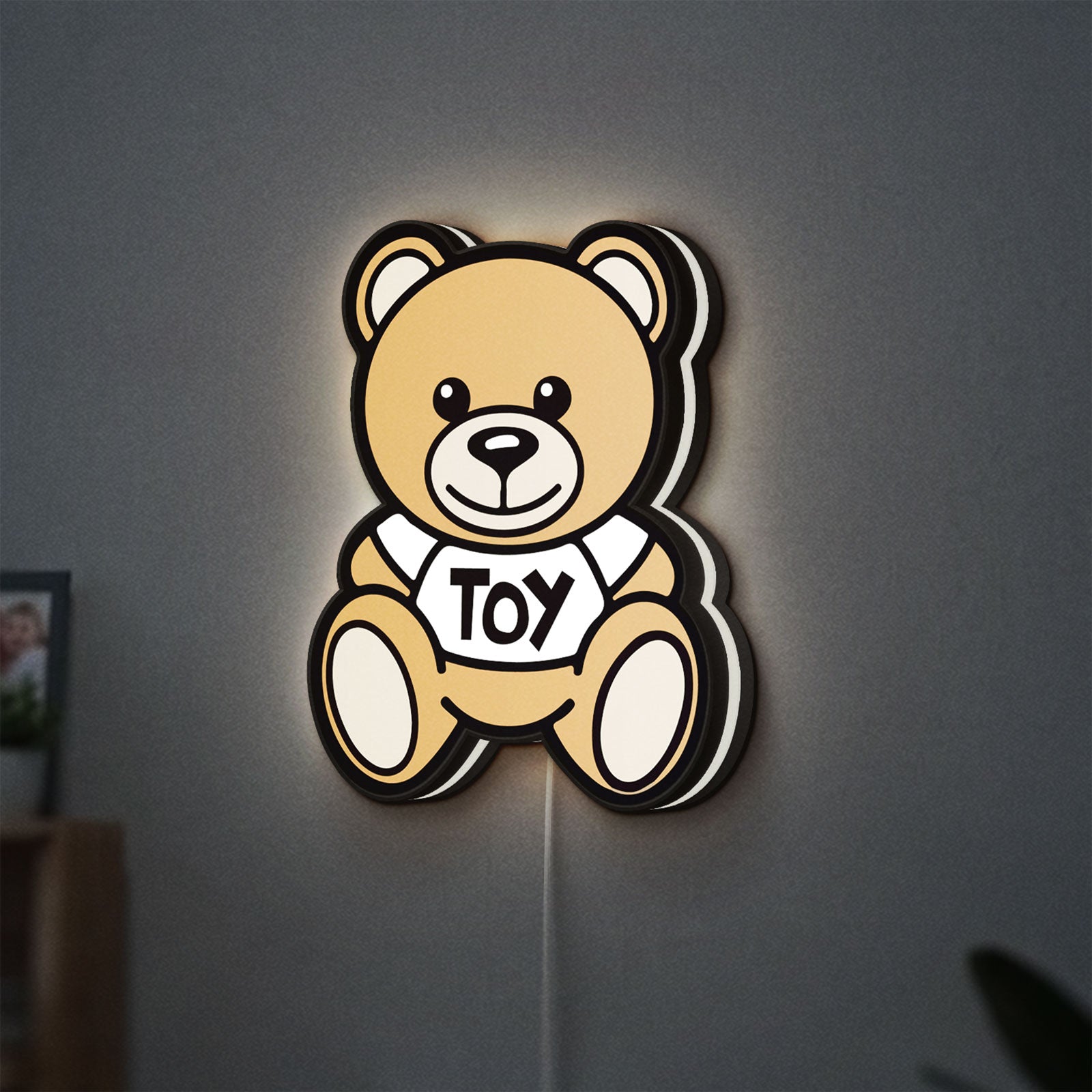 Oso Moschino Toy LED lightbox hanging on a wall with white glow