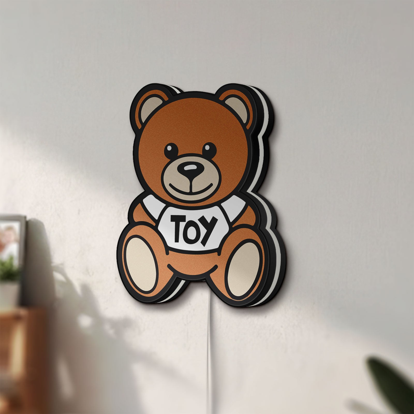 Unlit Oso Moschino Toy LED lightbox mounted on a wall in daylight