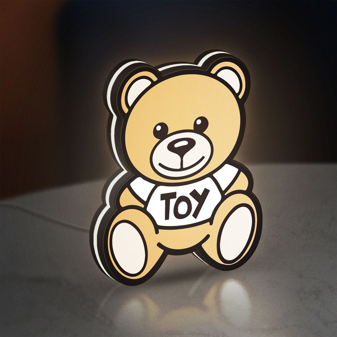 Oso Moschino Toy LED lightbox hanging on a wall with white glow