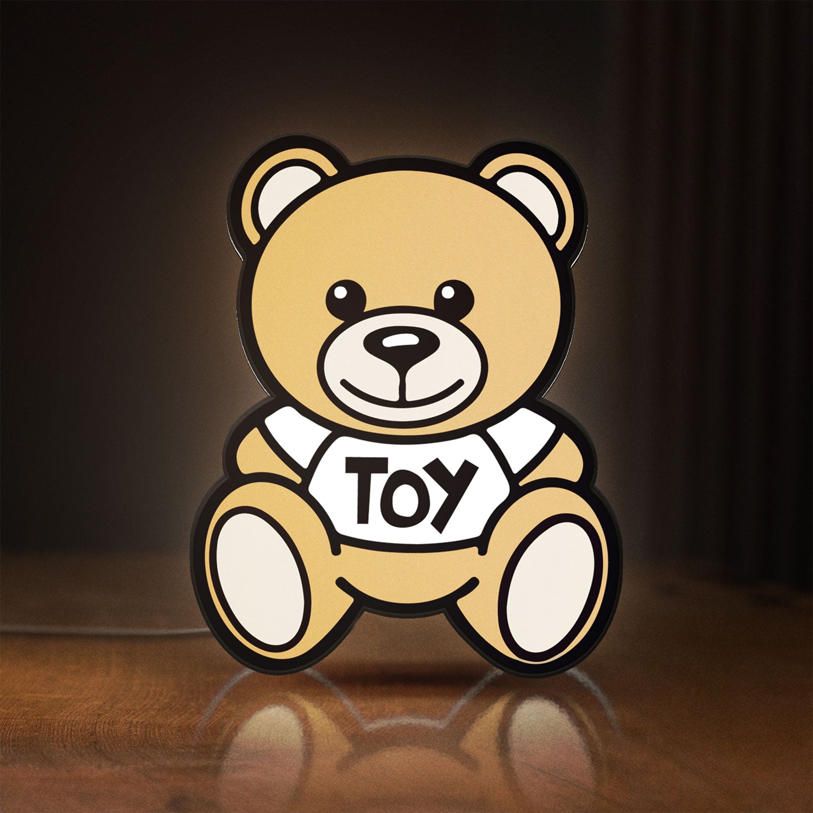 Front view of Oso Moschino Toy LED lightbox sign glowing on a wooden desk