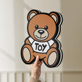 Unlit Oso Moschino Toy LED lightbox held by hand to show size and details