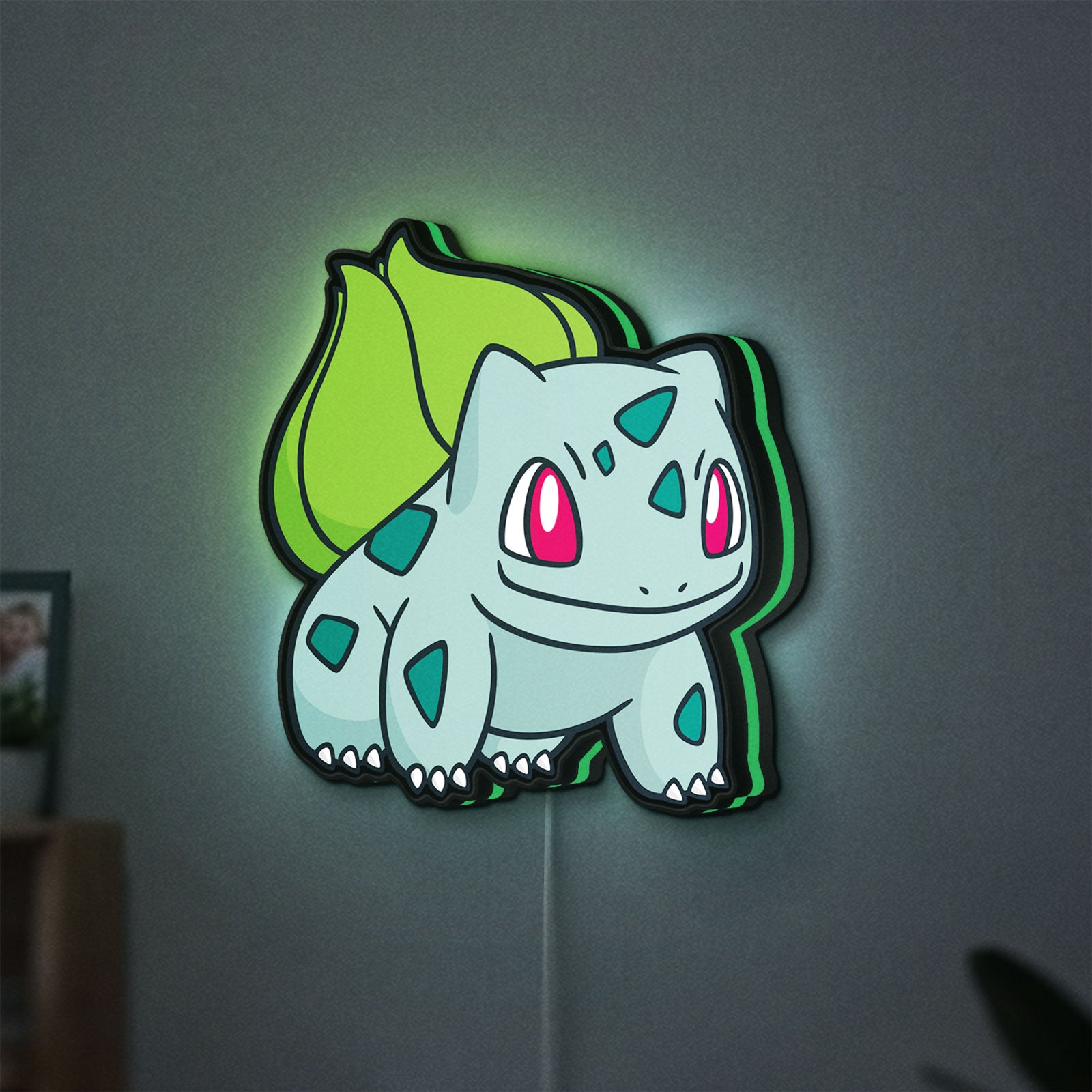Bulbasaur LED lightbox hanging on a wall with green glow