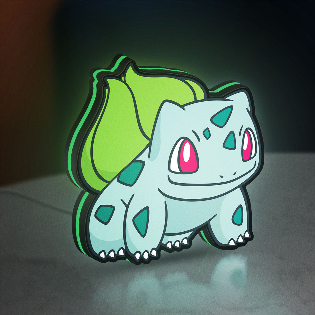Bulbasaur LED lightbox hanging on a wall with green glow