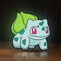 Front view of Bulbasaur LED lightbox sign glowing on a wooden desk