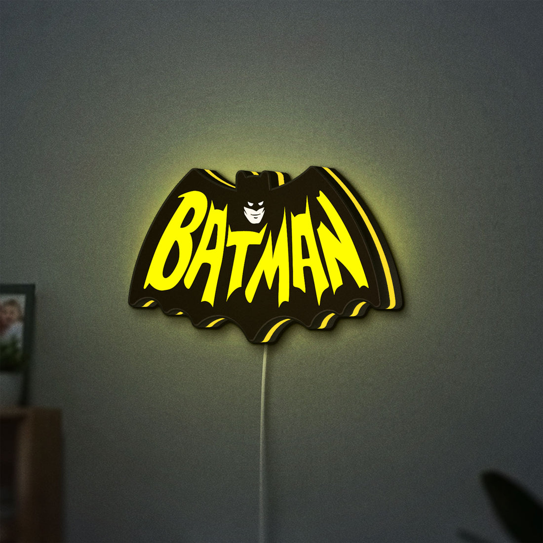Batman LED lightbox hanging on a wall with yellow glow