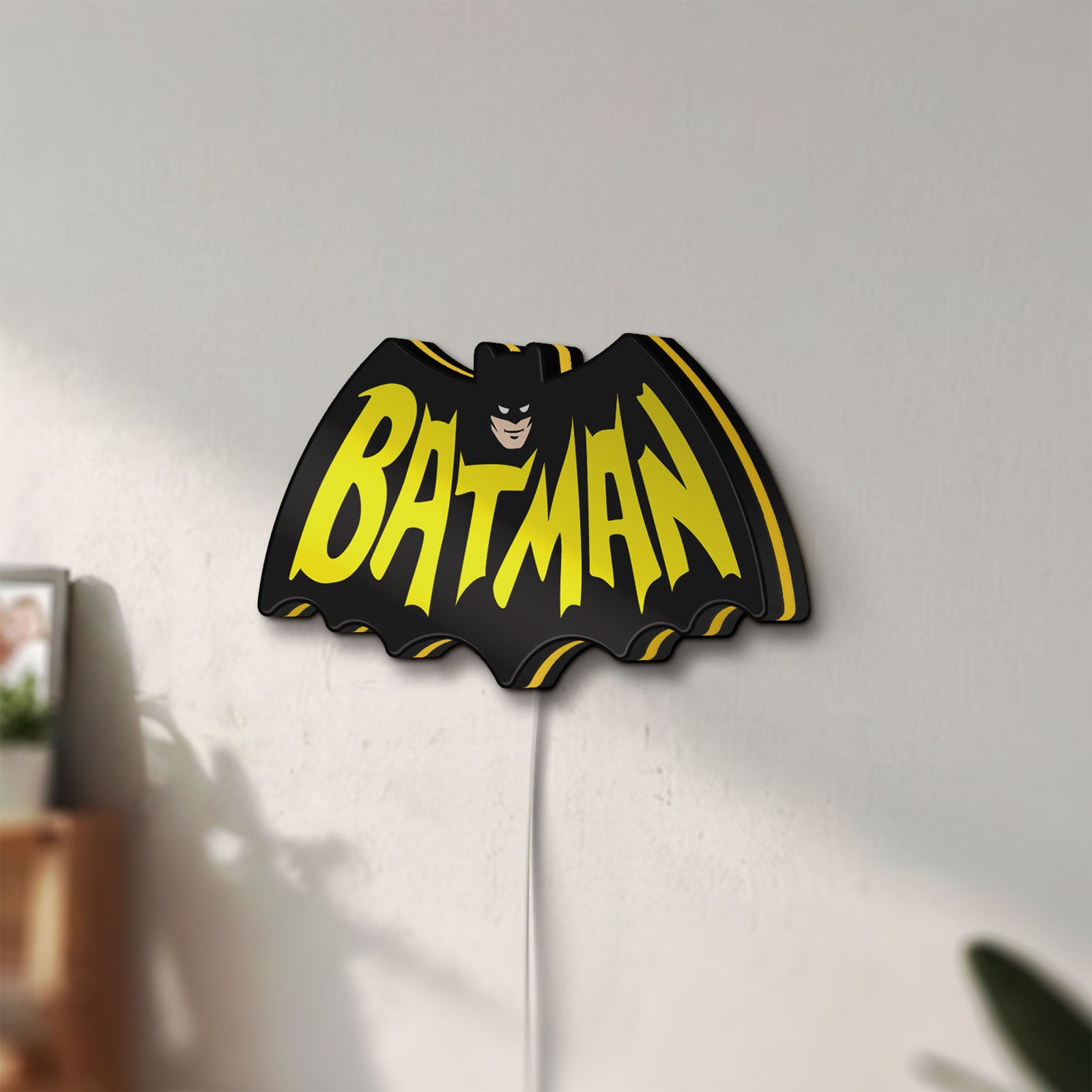 Unlit Batman LED lightbox mounted on a wall in daylight