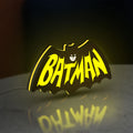 Batman LED lightbox standing on a desk from an angled side view with yellow glow