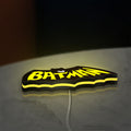 Batman LED lightbox lying flat on a desk with yellow glow