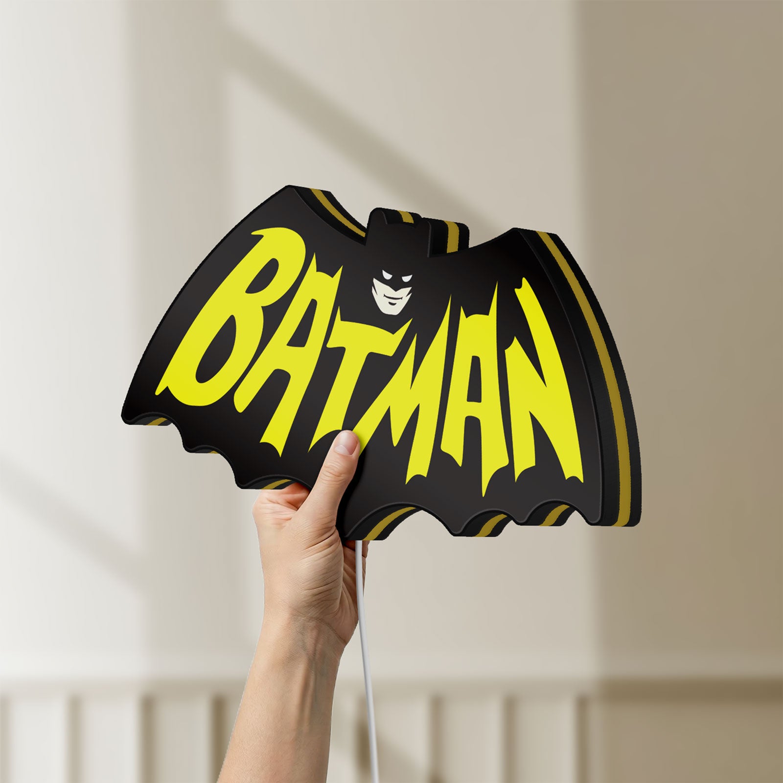 Unlit Batman LED lightbox held by hand to show size and details
