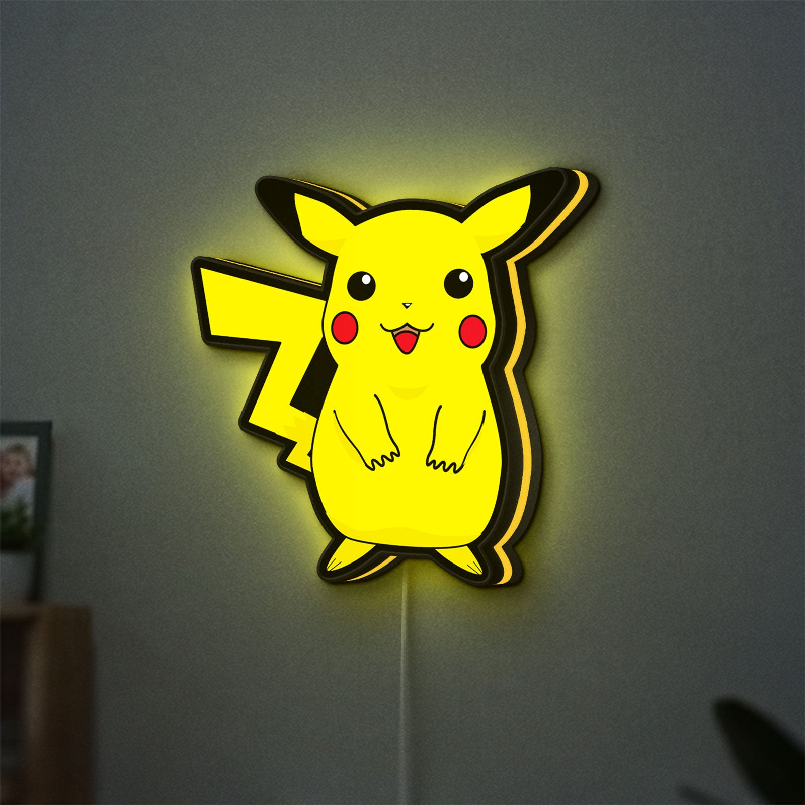 Pokemon LED lightbox hanging on a wall with yellow glow