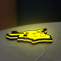 Pokemon LED lightbox lying flat on a desk with yellow glow