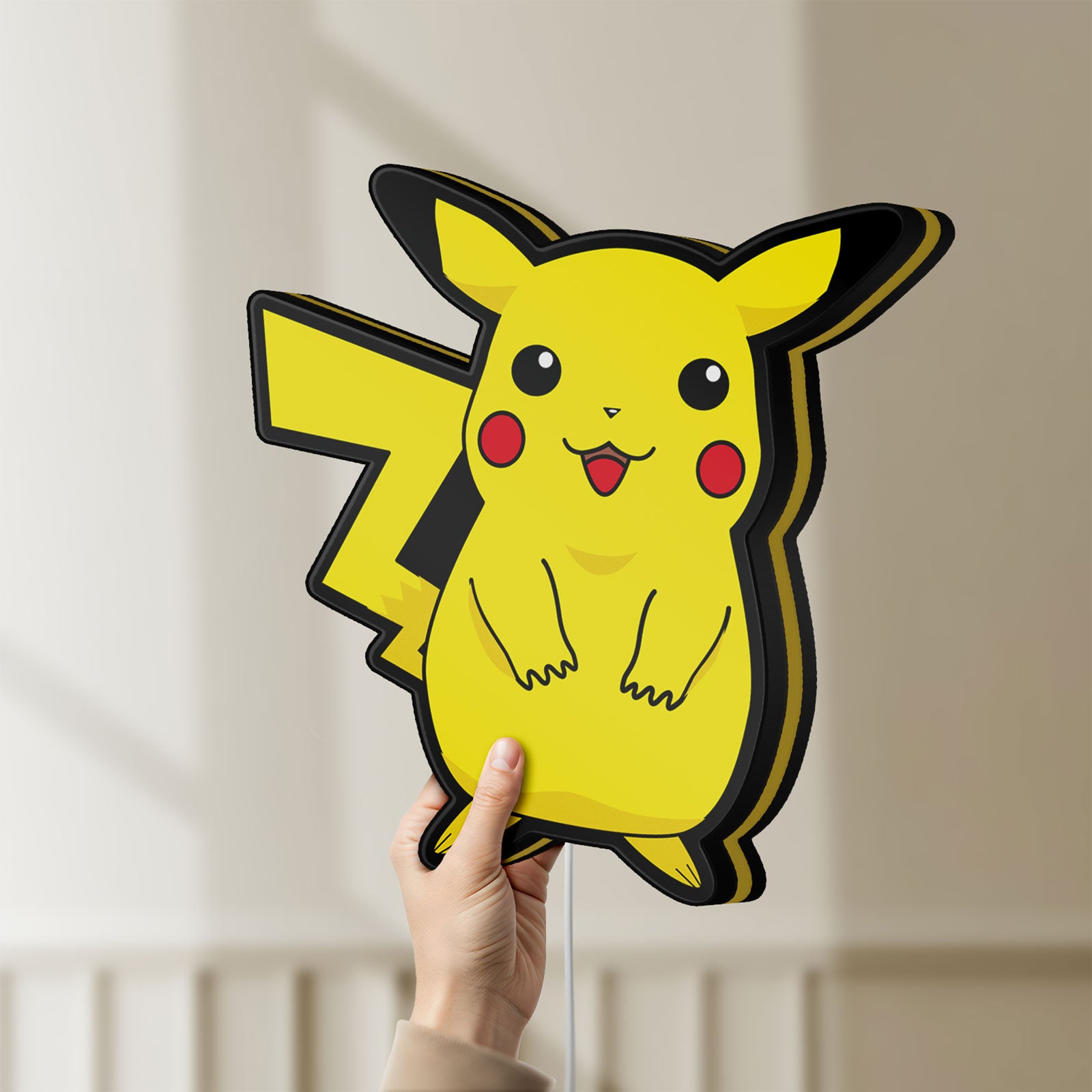 Unlit Pokemon LED lightbox held by hand to show size and details