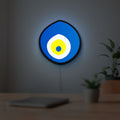 Nazar Boncugu LED lightbox hanging on a room wall with soft blue light