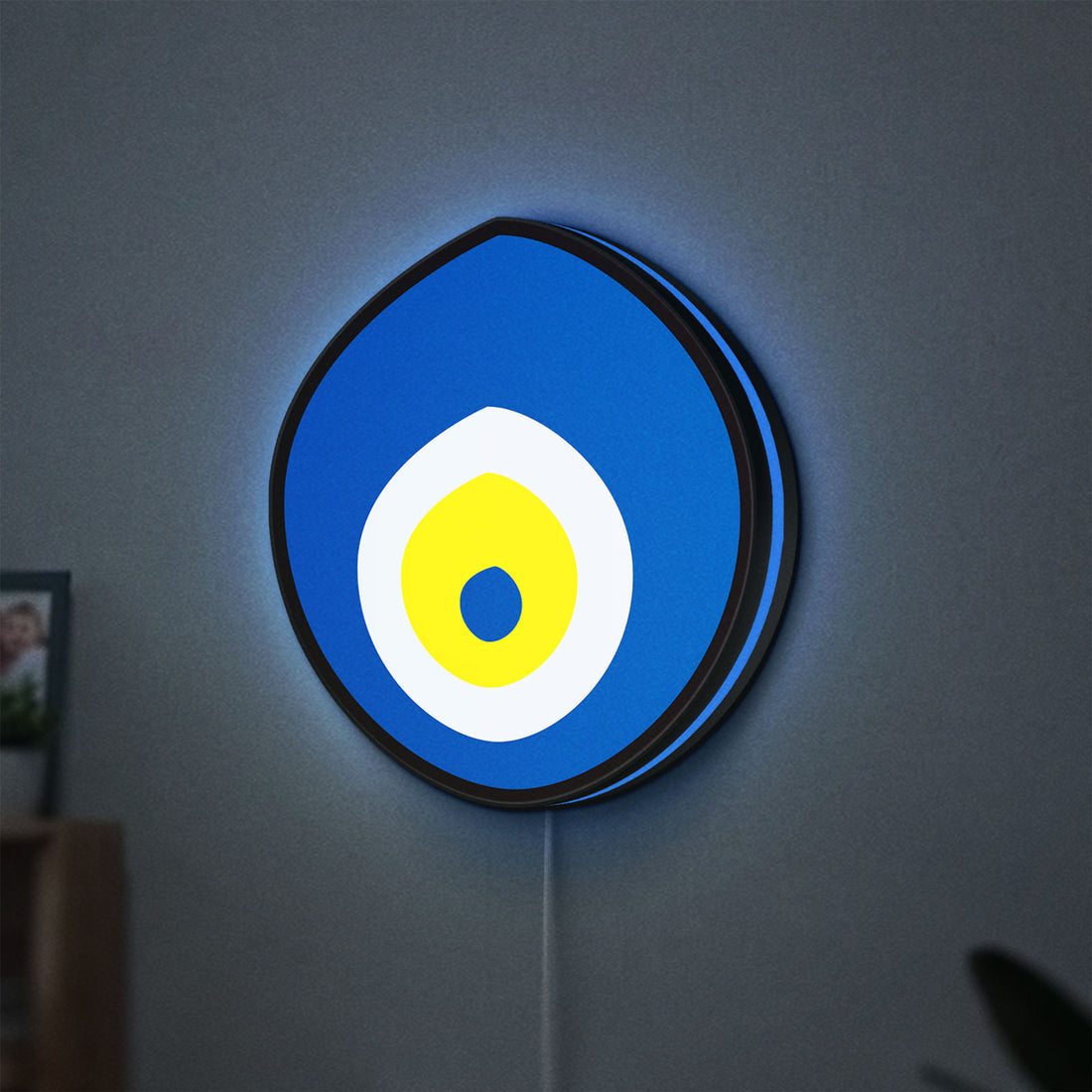 Nazar Boncugu LED lightbox hanging on a wall with blue glow