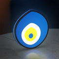Nazar Boncugu LED lightbox standing on a desk from an angled side view with blue glow