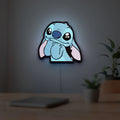 Lilo & Stitch LED lightbox hanging on a room wall with soft blue light