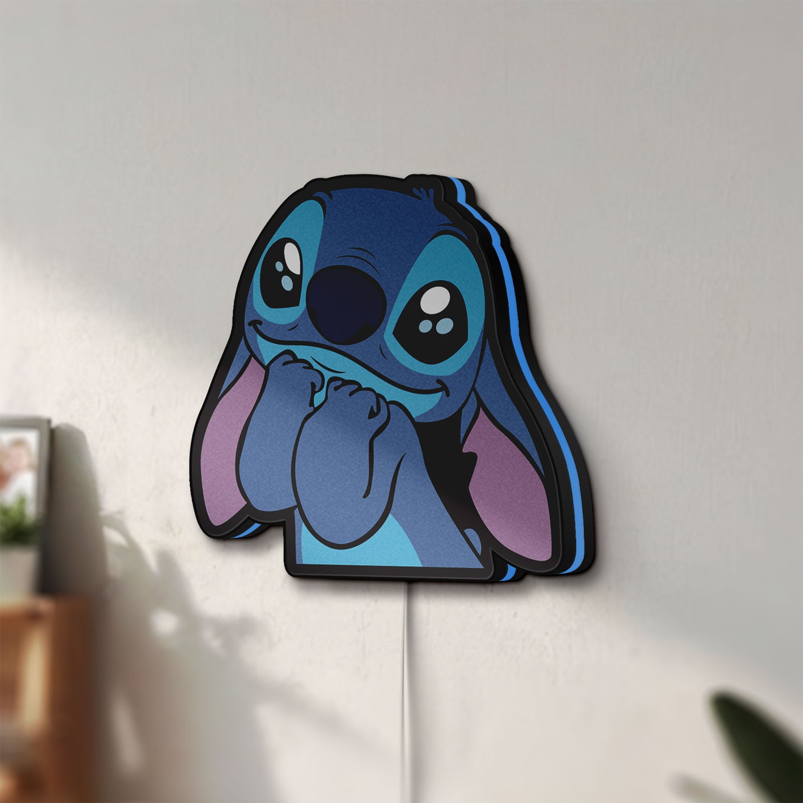 Unlit Lilo & Stitch LED lightbox mounted on a wall in daylight