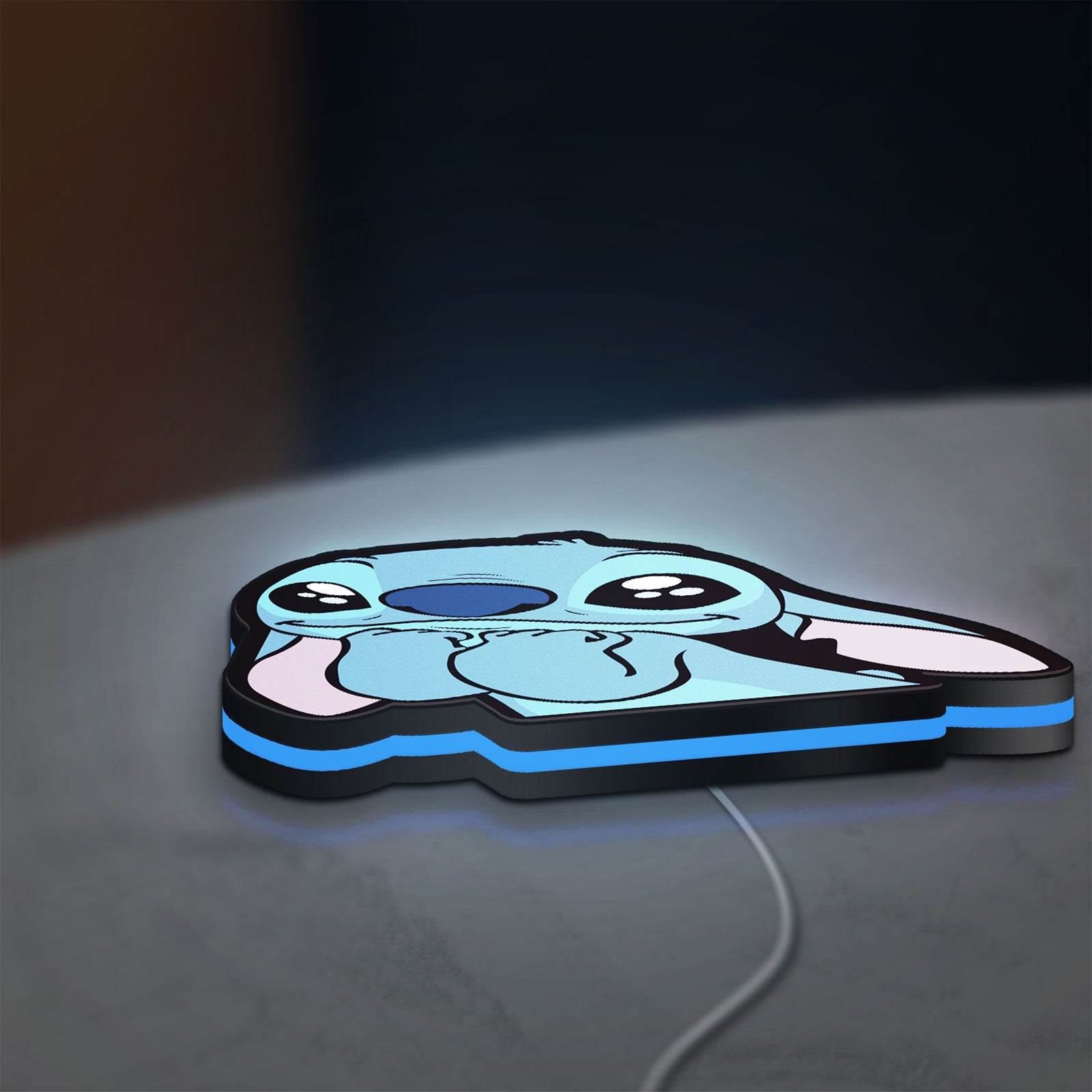 Lilo & Stitch LED lightbox lying flat on a desk with blue glow