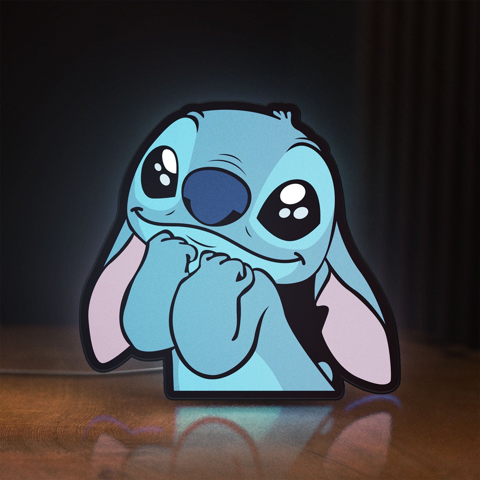 Front view of Lilo & Stitch LED lightbox sign glowing on a wooden desk